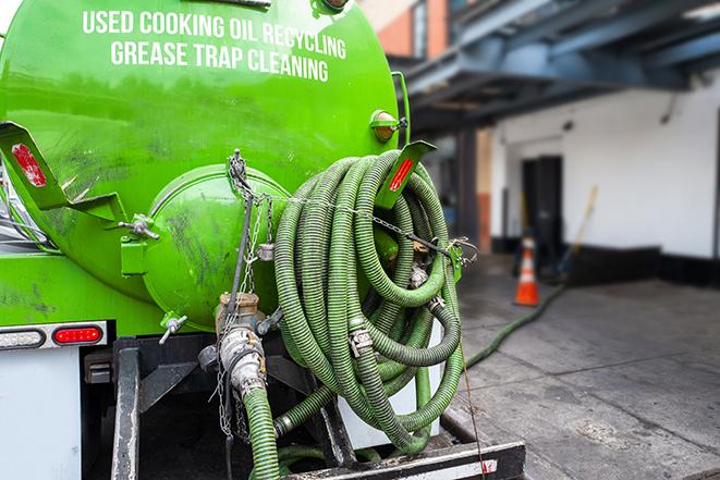 heavy-duty vacuum truck pumping out a grease trap in Brush Creek